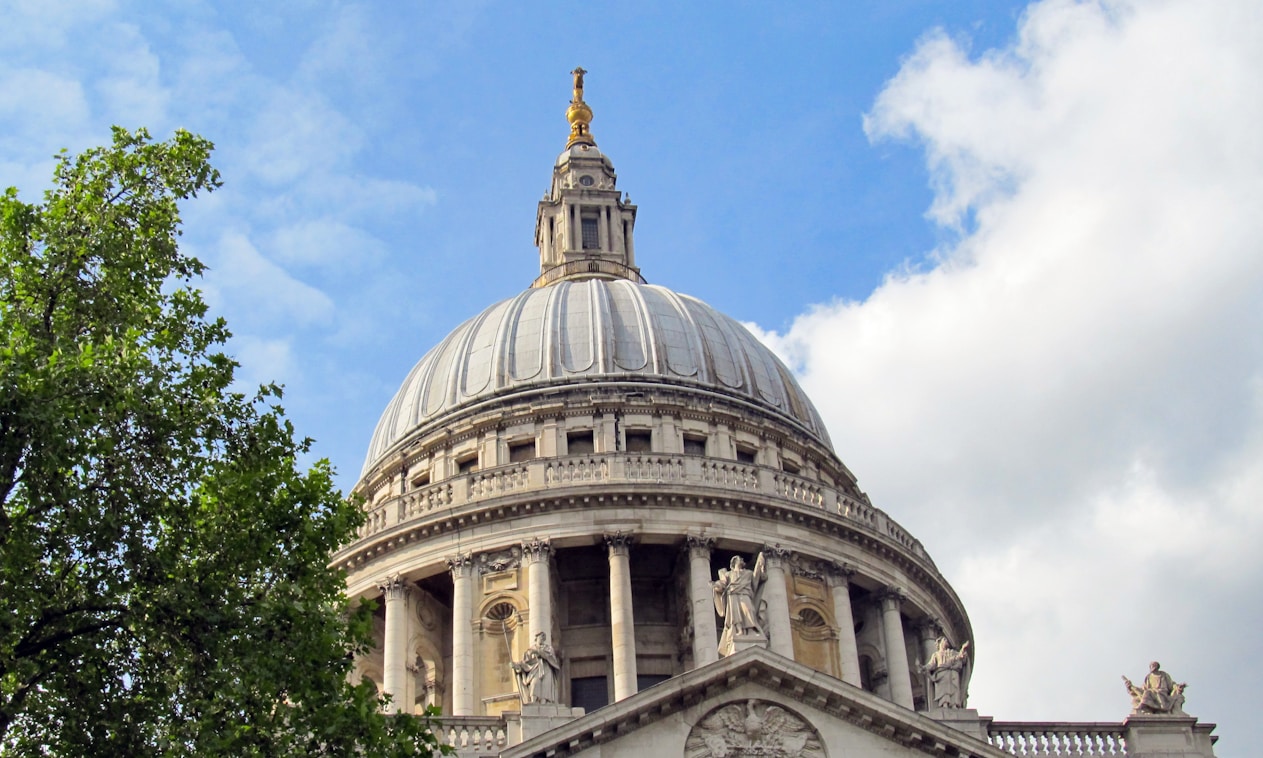 St Pauls cathedral with trees and a blue sky behind
