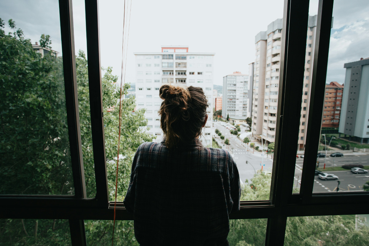 Person looking out the window over a london street