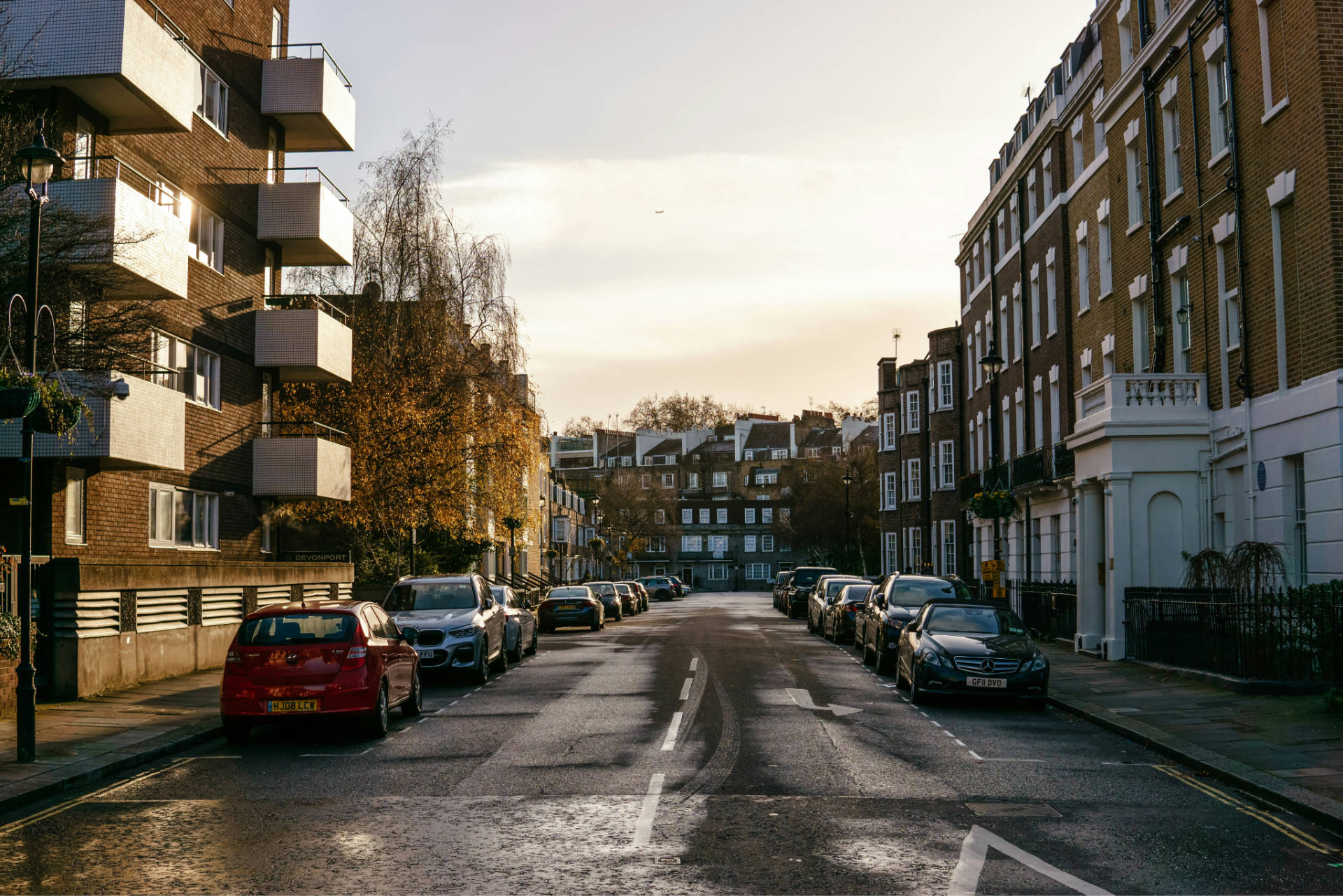 London street with traditional town house on the right and mid century flats on the left