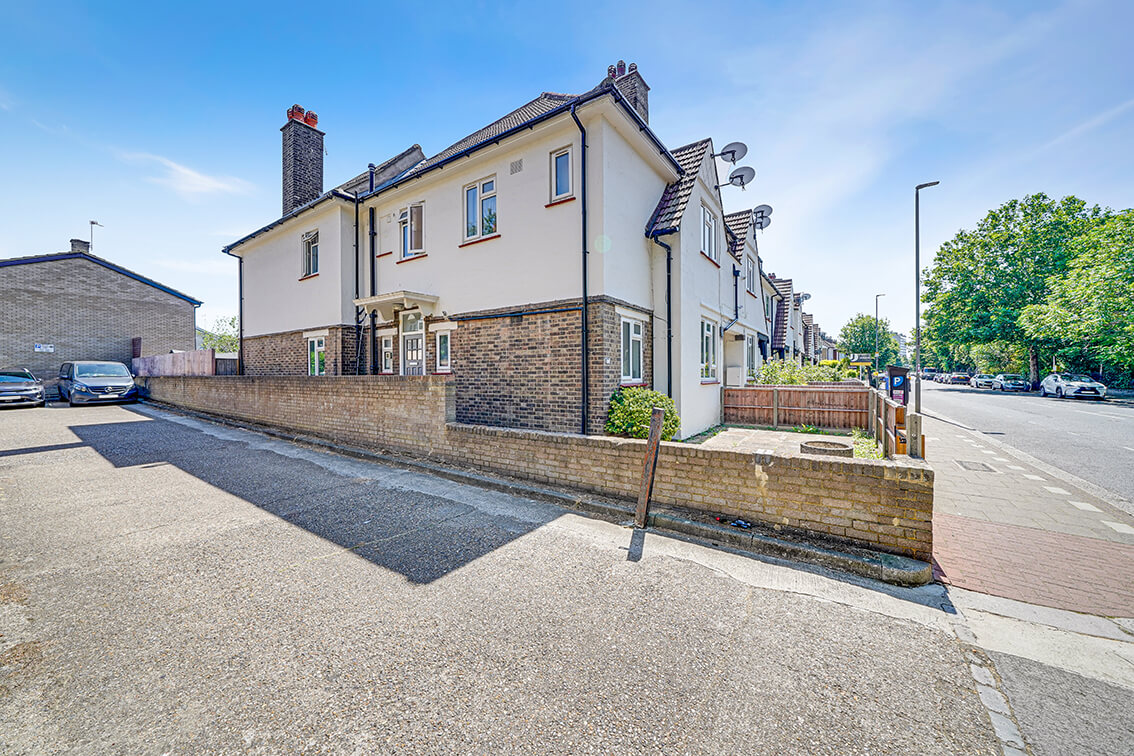 External view of a three storey terraced property on the corner of Blackshaw Road, with perimeter wall.
