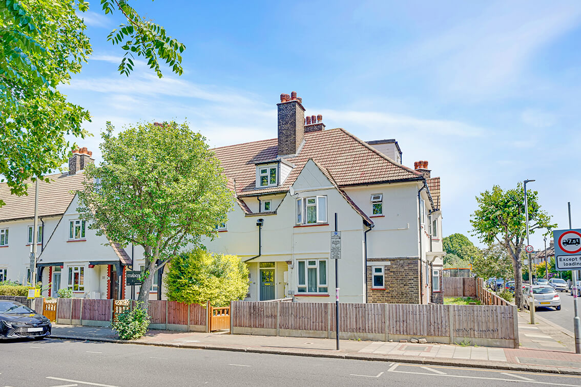 External view of a three storey terraced property on the corner of Blackshaw Road, with perimeter fencing and gate.
