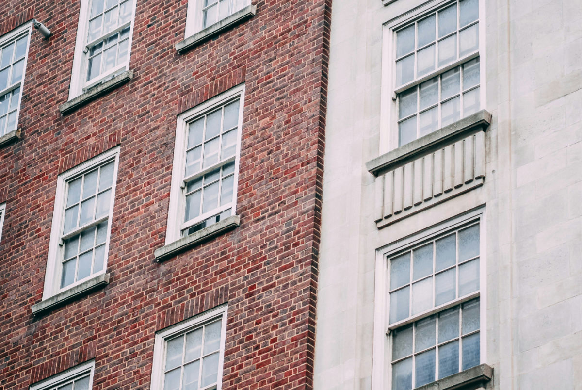 A sandstone and red brick building close up