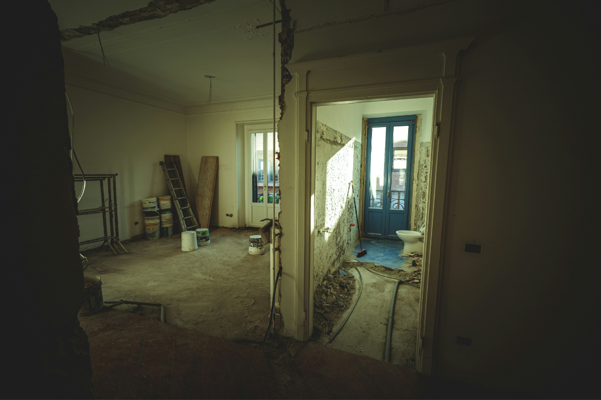 A rennovation of a house, internal walls are knocked down and builders tools are around the room